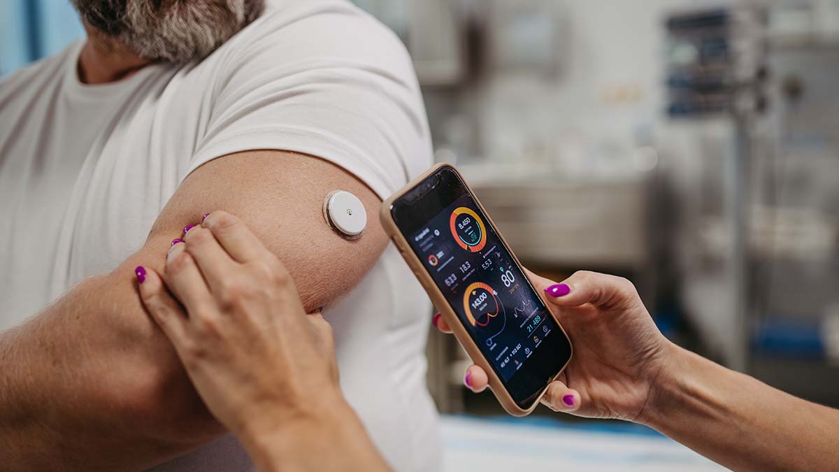 person wearing continuous glucose monitor